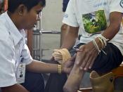 survivor has his prosthetic checked at COPE centre, Vientiane, Laos