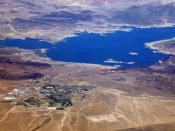 Lake Mead. Boulder City with its two golf courses and airport, is in the foreground. Hoover Dam is on the right.