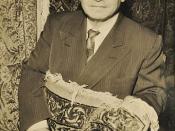English: Portrait of Aris Alexanian holding an oriental rug.