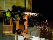 English: Workman cutting a old footbridge with Oxy-acetylene welding torch.