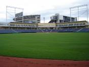 A view of Medlar Field at Lubrano Park looking from center field toward home plate. Beaver Stadium looms in the background. The blue seats are the COncourse Level seating, the Press Box is straight ahead and one level up from those seats, and it is flanke