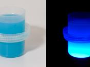 Liquid laundry detergent under ultraviolet light (UV). Manufacturers put fluorescent phosphors in detergent, so when clothes washed in the detergent are viewed in sunlight the UV light in in the sunlight causes them to glow or fluoresce making the clothes