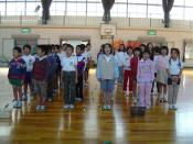 Students singing in a gym at a Japanese elementary school.