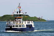 English: The Halifax III crossing the harbour from Halifax to Dartmouth, Nova Scotia. McNab's Island and lighthouse can be seen in the background.