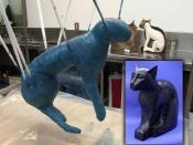 The foreground shows a cat undergoing Summum's modern mummification process. The cat's wrappings are receiving coats of polyurethane. In the background, another cat is being fitted into a sculpted bronze Mummiform®. The inset shows a finished cat mumm