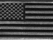 English: A subdued-color version of the flag of the United States, in the form of a patch intended to blend with urban camouflage.