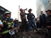 Bush, standing with firefighter Bob Beckwith, addresses rescue workers at Ground Zero in New York, September 14, 2001.