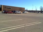 English: Pheasant Lane Mall parking lot in Nashua, NH, USA. The line in the center is the State Line between New Hampshire (L) and Massachusetts (R). Note the corner of JC Penney which does not reach into MA for sales tax reasons. See associated article.