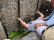 Person kissing the Blarney Stone at Blarney Castle, Ireland.