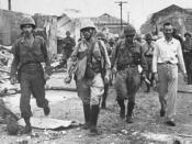 English: World War II. Ernest Stanley (white shirt) accompanies Japanese soldiers out of Santo Tomas Internment Camp, Manila, Feb 1945