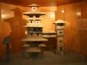 A Han Dynasty (202 BC – 220 AD) Chinese miniature model of two residential towers joined by a bridge