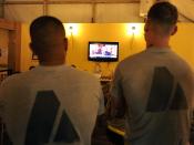 English: Two U.S. Army soldiers watch President Obama talk about the details of the death of 9/11 mastermind Osama bin Laden on the television inside the USO at Kandahar Airfield, Afghanistan, May 2.