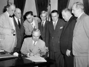 President Harry S Truman signs the Atomic Energy Act of 1946 establishing the U.S. Atomic Energy Commission. Behind the President, left to right: Senators Tom Connally, Eugene D. Millikin, Edwin C. Johnson, Thomas C. Hart, Brien McMahon, Warren R. Austin,