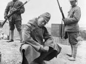 A captured Japanese soldier crouches before his Chinese captors at Changde in the Hunan Province.1943 Battle of Changde. November 2, 1943 - December 20, 1943