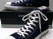 A classic Black pair of Converse All-Stars resting on the Black & White Ed. Shoebox (1998-2002)