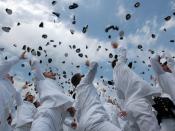 Newly commissioned officers celebrate their new positions by throwing their midshipmen covers into the air as part of the U.S. Naval Academy class of 2005 graduation and commissioning ceremony.