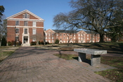 English: The campus of the Southeastern Baptist Theological Seminary in Wake Forest, North Carolina, showing Botswick Hall (left) and Goldston Hall (right) in the background and a bench dedicated to G. Paul Fletcher in the foreground.