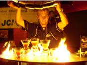 English: How to pour 5 martinis at the same time while on fire: 