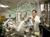 A scientist at Naval Surface Warfare Center adjusts the flow of argon gas.