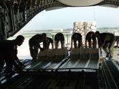 English: Airmen from the 300th Airlift Squadron at Charleston Air Force Base, S.C., and the 433rd Civil Engineer Squadron at Lackland AFB, Texas, load cargo for transport to Saint Lucia Friday, April 7, 2006. The aircrew was delivering construction materi