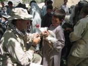 Provincial Reconstruction Team veterinarian vaccinates a chicken. Keywords: Afghanistan Farm Animals Chickens Veterinary Livestock Children Boys.