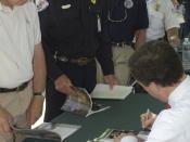 Denver, CO, May 21, 2004 -- Homeland Security Under Secretary and director of FEMA Michael D. Brown signs books for firefighters. Brown was in Golden for the national roll-out of FEMA's fire book "At Home In The Woods, lessons learned in the wildland