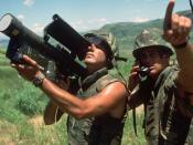 English: A US Marine with a field radio relays the direction of aircraft approaching the Crow Valley Electronic Warfare Tactical Range to the operator of an FIM-92 Stinger missile launcher during Exercise COPE THUNDER '84-7.