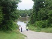 English: Some residents of rural Grayson County, TX. discover that the way home is blocked by flood waters.
