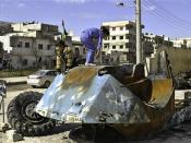 Syrian girls play on top of a destroyed Syrian riot police tank at Bayada neighborhood in Homs Syria