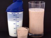 English: A chocolate-flavored multi-protein nutritional supplement milkshake (right), consisting of circa 25g protein powder (center) and 300ml milk (left).