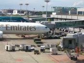 View of the ground handling services of Singapore Changi Airport, servicing an Emirates Boeing 777-300 (A6-EMO), with a Cathay Pacific 