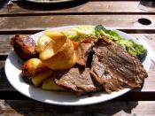 A Sunday roast consisting of roast beef, roast potatoes, vegetables, and yorkshire pudding