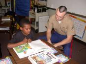 English: Park Street Elementary School, Atlanta, Ga. (Dec. 11, 2002) -- A U.S. Marine helps a student with reading comprehension as part of a Partnership in Education program sponsored by Park Street Elementary School and Navy /Marine Corps Reserve Center