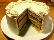 English: A layered pound cake, with alternating interstitial spaces filled with raspberry jam and lemon curd, finished with buttercream frosting.