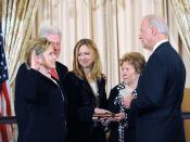 English: Secretary of State Hillary Clinton ceremonially sworn in by Vice President Biden with former President Clinton, their daughter Chelsea, and her mother Dorothy at her side.