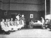 1898 photograph of a group of young girls learning how to make a bed at a 