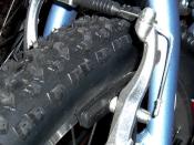 Linear-pull brake, also known by the Shimano trademark: V-Brake, on rear wheel of a mountain bike