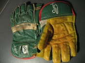A pair of wicket-keeping gloves. The webbing which helps the keeper to catch the ball can be seen between the thumb and index fingers.