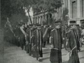 English: Boys in robes in a funeral procession. Black-and-white photograph.