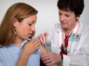 English: This 2006 image depicted an adolescent female in the process of receiving an intramuscular immunization in her left shoulder muscle, from a qualified nurse. The girl was assisting in the procedure by holding up her sleeve, while watching as the i