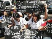 Student protesters shout slogans as they block a busy street to call for the ouster of Philippine President Gloria Macapagal Arroyo in Manila on Tuesday Feb. 21, 2006