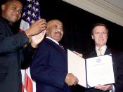 English: Master Chief Petty Officer Carl Brashear (center), the Navy's first African-American diver, received an Outstanding Public Service Award in October 2000 from actor Cuba Gooding Jr. and then-Defense Secretary William Cohen for 42 years of combined