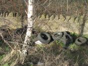 English: Dumped tyres A common roadside sight, courtesy of your local moron. A lot of tyres supposedly out of sight beside the B6371