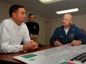 US Navy 080326-N-4480S-020 Capt. Patrick Hall, commanding officer of the aircraft carrier USS Abraham Lincoln (CVN-72), discusses the Franklin-Covey Leadership Program and the Deck Departmental Scoreboard with Lt. Cmdr. John Re