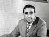 Edward Teller, in 1958, as Director of Lawrence Livermore National Laboratory. Note that the picture at his top left is of the Alpha Calutron Racetrack from the Manhattan Project, and the picture at his top right is of the 1953 BADGER nuclear test. Image 