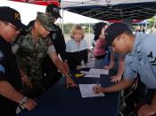 US Navy 070614-N-3390M-001 Religious Program Specialist 2nd Class Delmar Ramirez, right, visits Naval Station Everett^rsquo,s security department recruiting booth at a job fair held at the Smokey Point Naval Support Complex dur