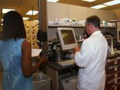 English: National Naval Medical Center, Bethesda, Md., (Aug. 19, 2003) -- Pharmacist Randal Heller, right, verifies the dosage and medication of a prescription at the National Naval Medical Center in Bethesda, Maryland. Heller checks all prescriptions dis
