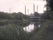 English: Rockware Glass Works, 1973. A sadly faded slide, looking south down the canal towpath to the glass works
