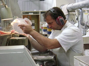 English: An employee at Waterford Crystal glass cutting.