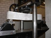A testing machine measuring the tensile strength of a concrete beam